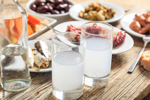 Two glasses of ouzo and appetizers