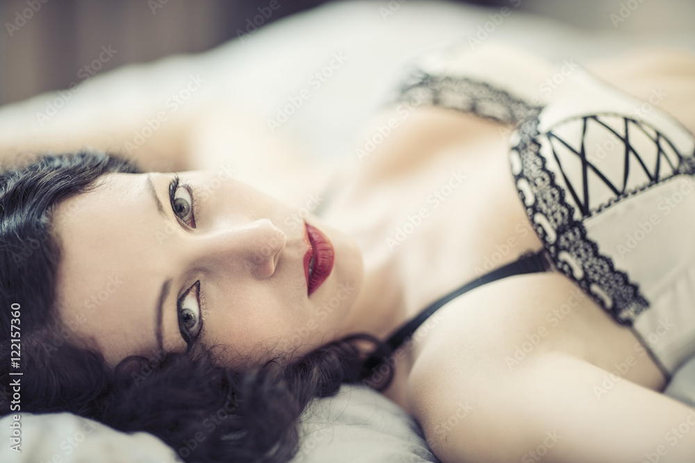 Young woman in lingerie lying on bed Young woman in lingerie lying on bed