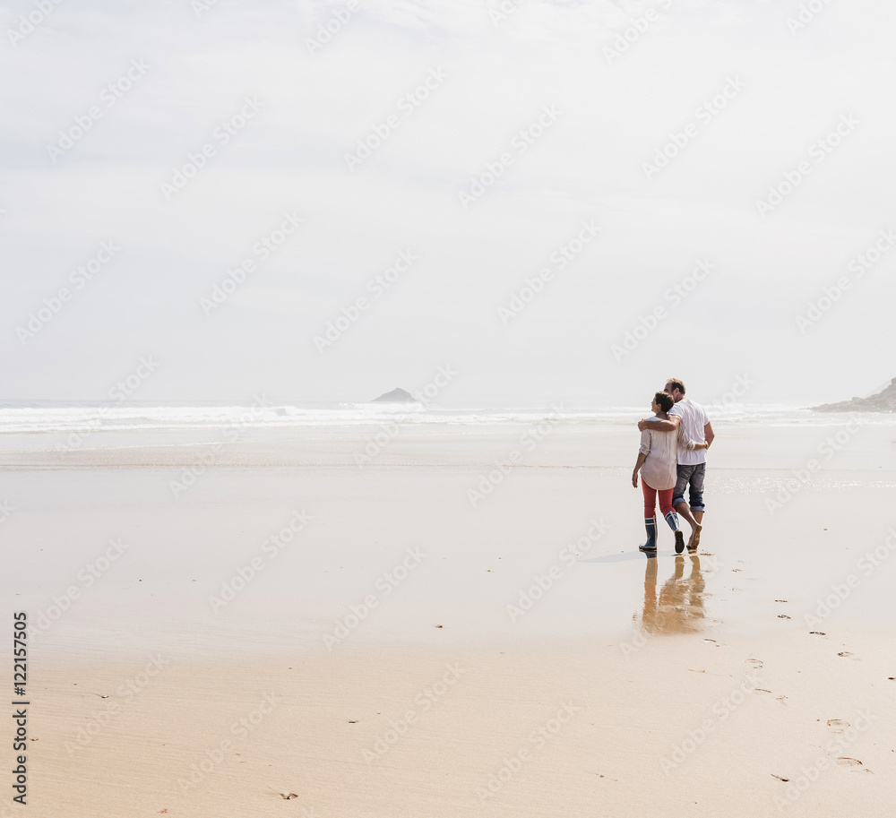 Mature couple walking on the beach Mature couple walking on the beach