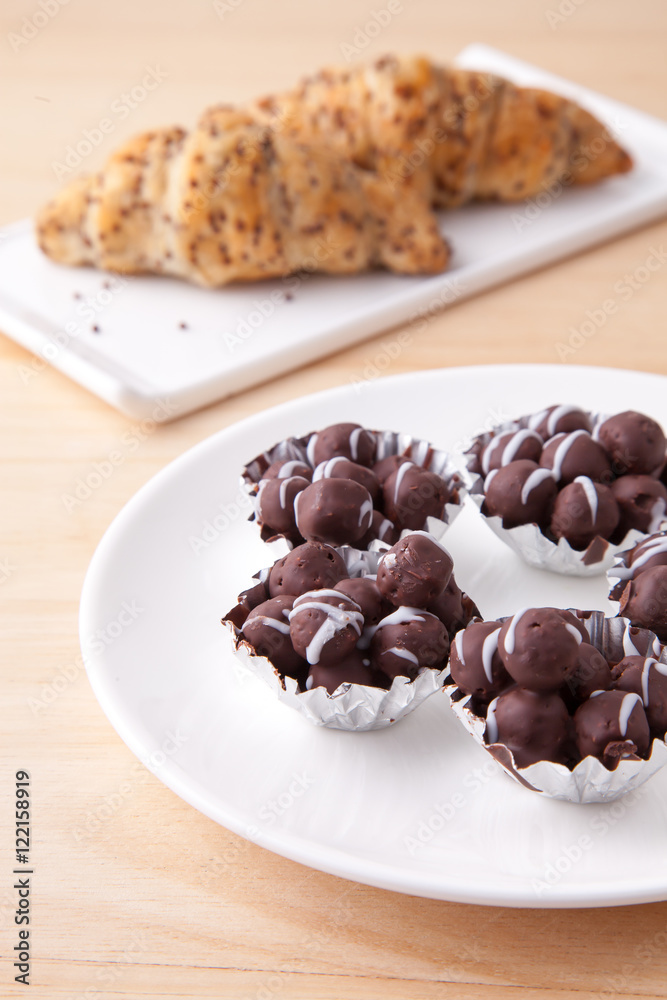 Chocolate and bun on wood table Chocolate and bun on wood table