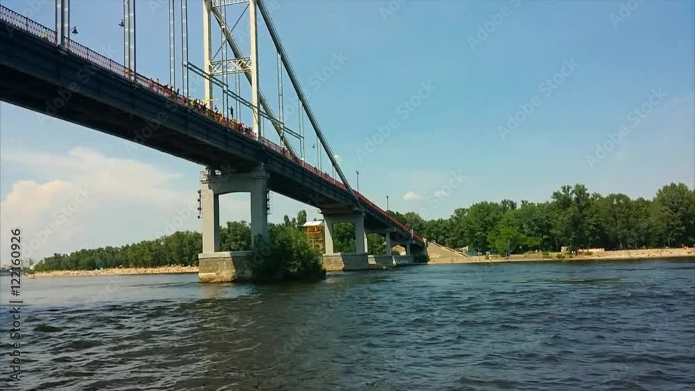 river trip on a boat under the bridge picturesque banks coast of Dnipro river at Kyiv Ukraine river trip on a boat under the bridge picturesque banks coast of Dnipro river at Kyiv Ukraine