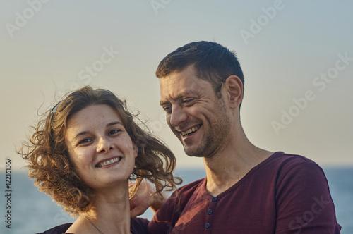 Young couple kissing on a sunset