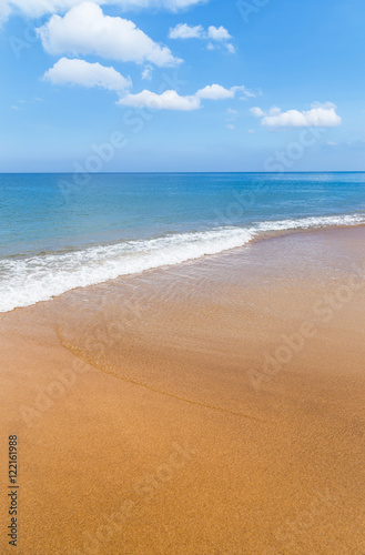 white soft wave on tropical beach and blue sea with white cloud and blue sky background