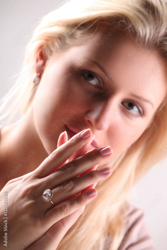 Beautiful young blonde shows off jewelry ring with stone Beautiful young blonde shows off jewelry ring with stone