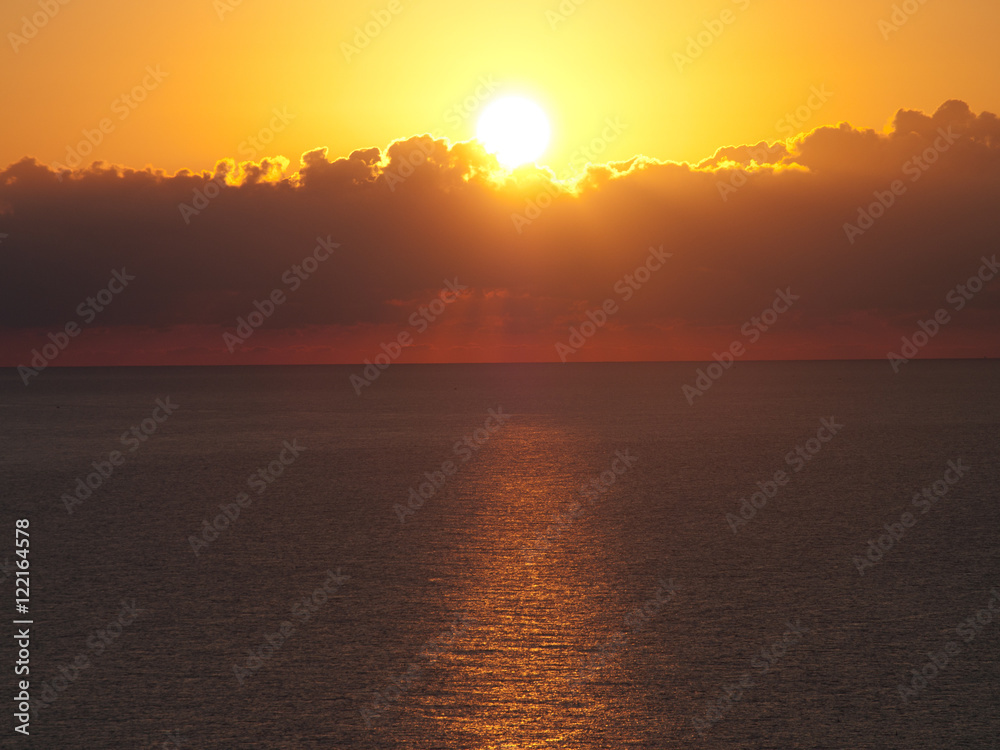 Beautiful Sunrise over a Ocean with reflections on the water