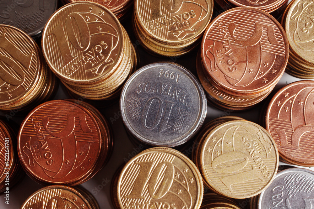 Piles of brazilian coins (money) on white background