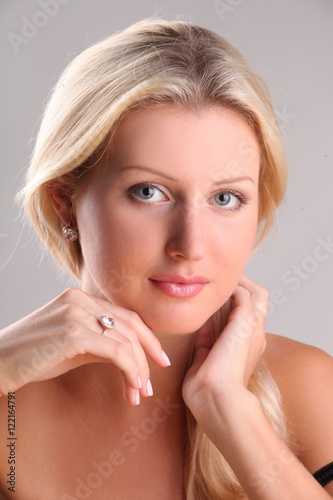 Beautiful young blonde shows off jewelry ring with stone