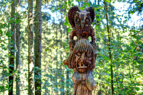 Old wooden sculptures in the forest. Witch Hill park  Lithuania.