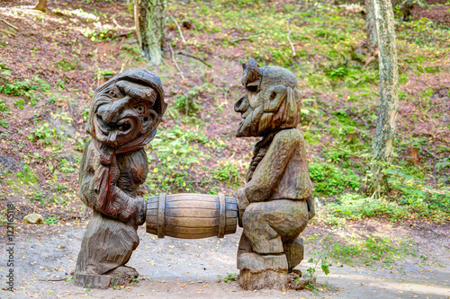 Old wooden sculptures in the forest. Witch Hill park  Lithuania.