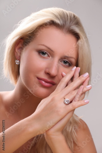 Beautiful young blonde shows off jewelry ring with stone