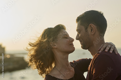 Young couple kissing on a sunset