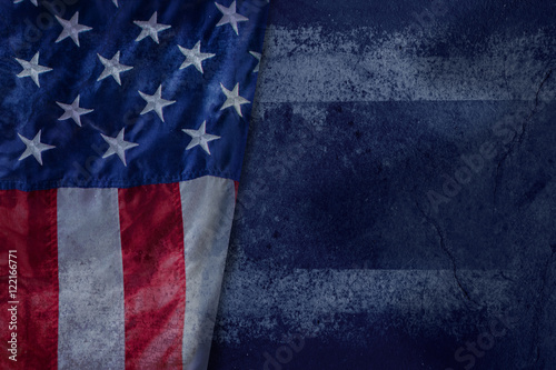 Vintage American flag on a Grunge Blue Cement background with copy space