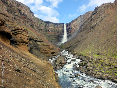 Hengifoss waterfall in Iceland with red rock striations 