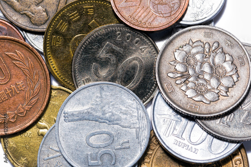 Stacks of Slovakia, Japan, Indonesia, Korea coins on a white background photo