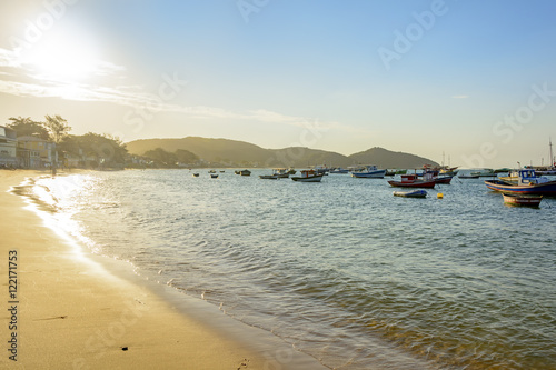 Sunset on the beach in Buzios resort with their boats and landscape