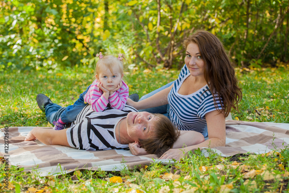 happy family in autumn park in the same dress at a picnic happy family in autumn park in the same dress at a picnic