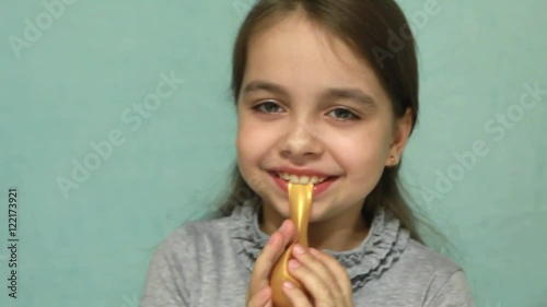 Funny and happy girl trying to inflate the ball