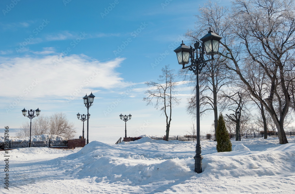 City winter embankment with lanterns
