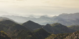 Sunset in the mountain natural landscape. Green valley on background dramatic sky and clouds. Panorama  horizon view of scenery  foggy hills Northern Spain alps. Travel mockup concept in evening time.