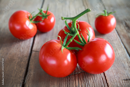 Sweet tomatoes isolated on wooden background
