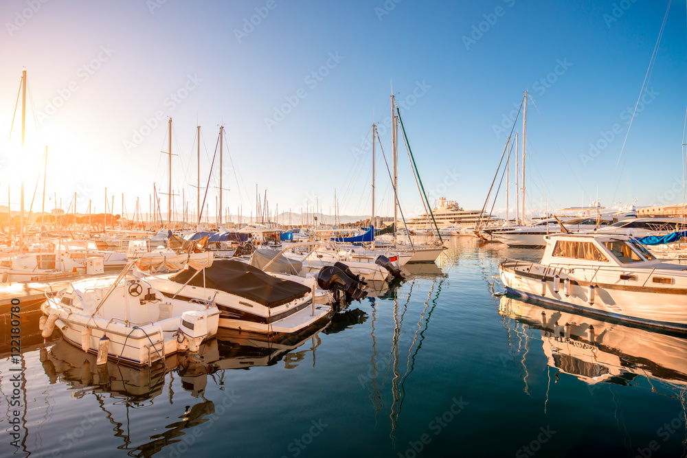 Fototapeta premium Sunset view on the harbor with expensive yachts on the french riviera in Antibes village in France
