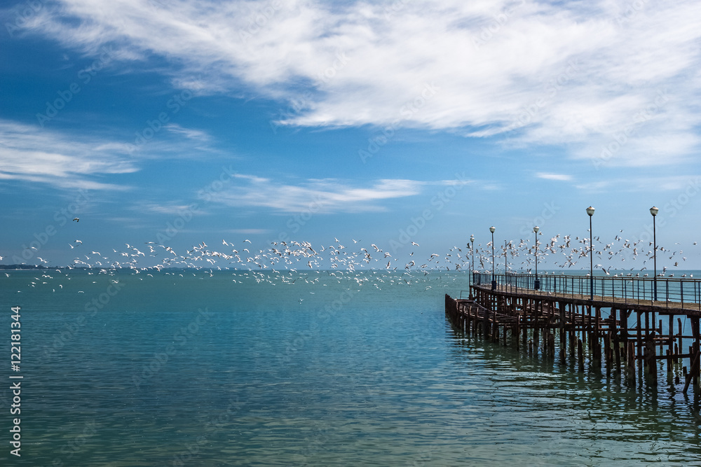 Old pier and seagulls over the sea Old pier and seagulls over the sea