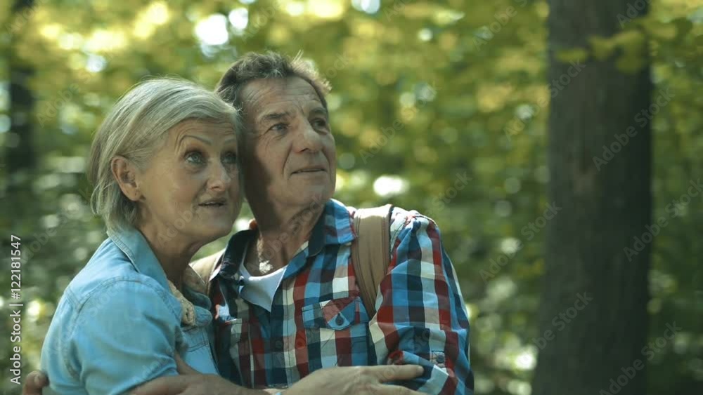 Beautiful senior couple on a walk on sunny summer day Beautiful senior couple on a walk on sunny summer day