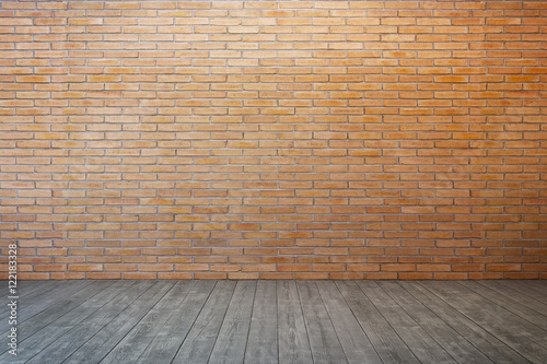 empty room with brick wall and wood floor