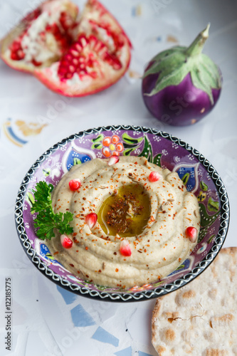 Arabic food baba ghanoush close-up on the plate and ingredients the table. vertical