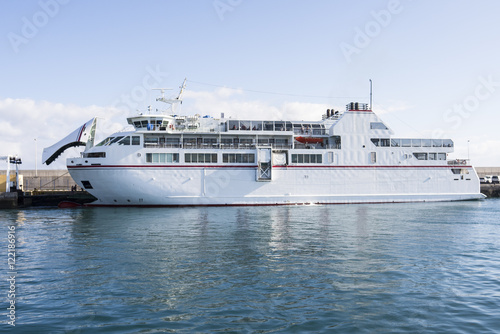 White auto ferry lying at the jetty with blue skies and turquois © sotavento1000