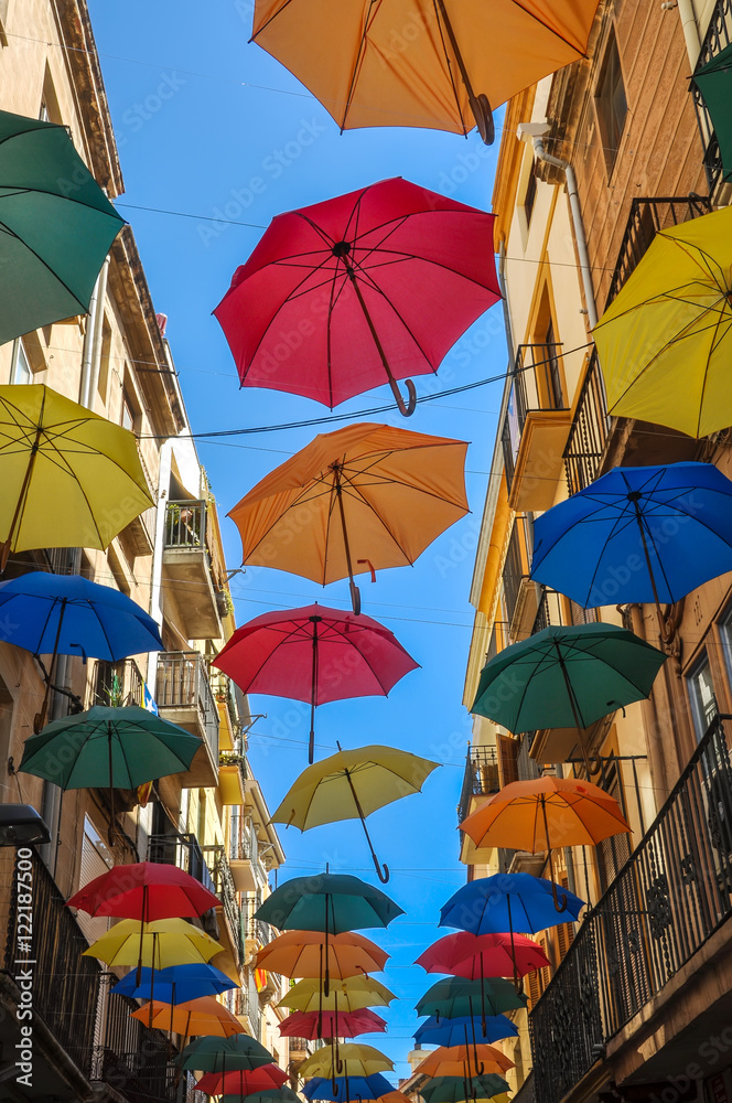 Antique street decorated with colored umbrellas.