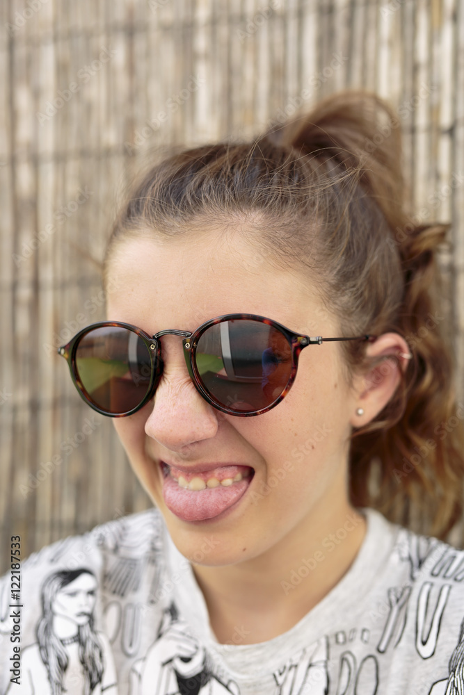 Young girl with sunglasses. vertical capture. Young girl with sunglasses. vertical capture.