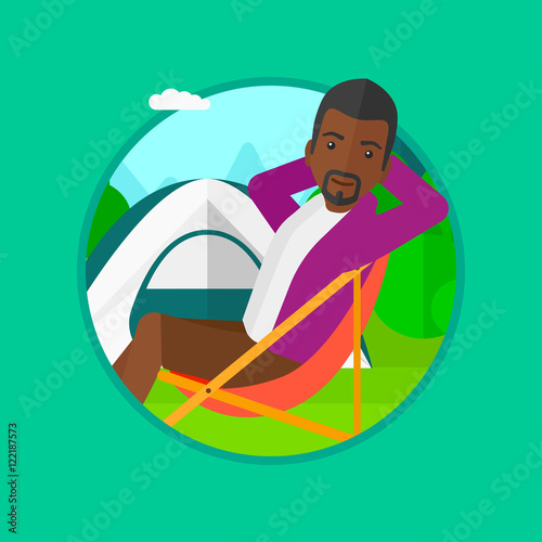Man sitting in folding chair in the camp.