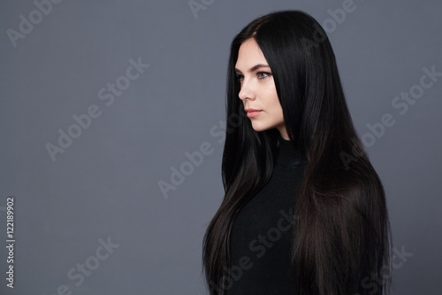 Fotografie, Tablou Beautiful brunette woman with well-groomed long hair, gray background