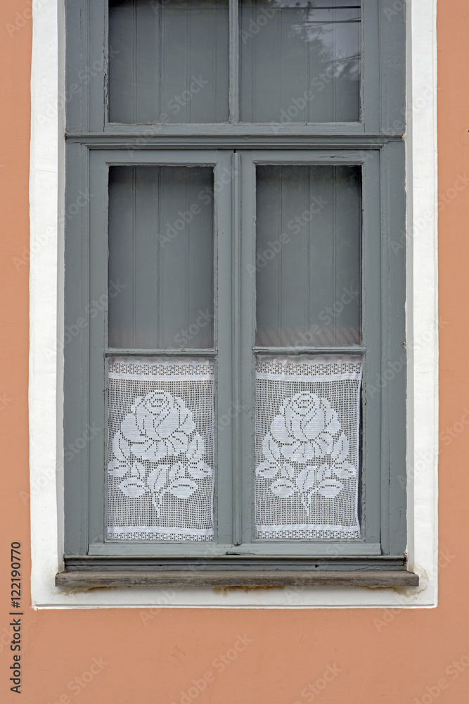 Window with crochet curtain with floral motif Window with crochet curtain with floral motif