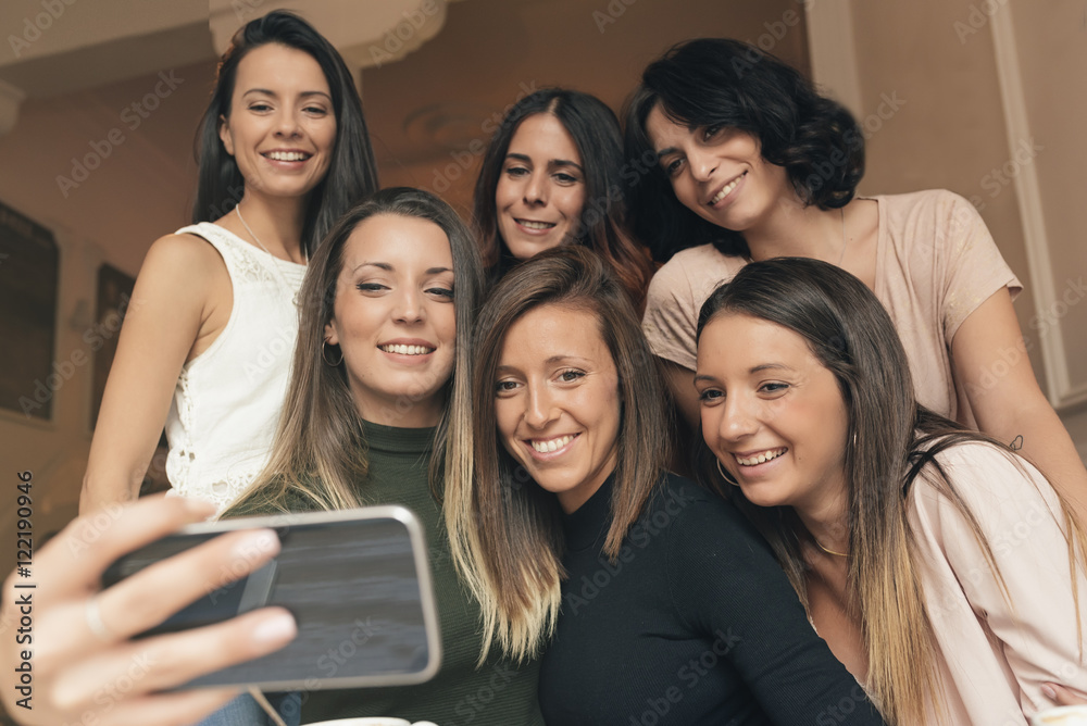 Friends taking a photo with a phone. Friends taking a photo with a phone.