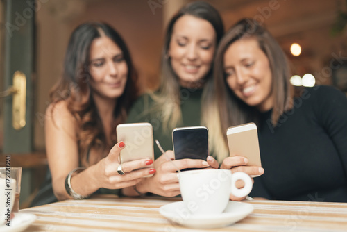 Friends watching social media in a smart phone.