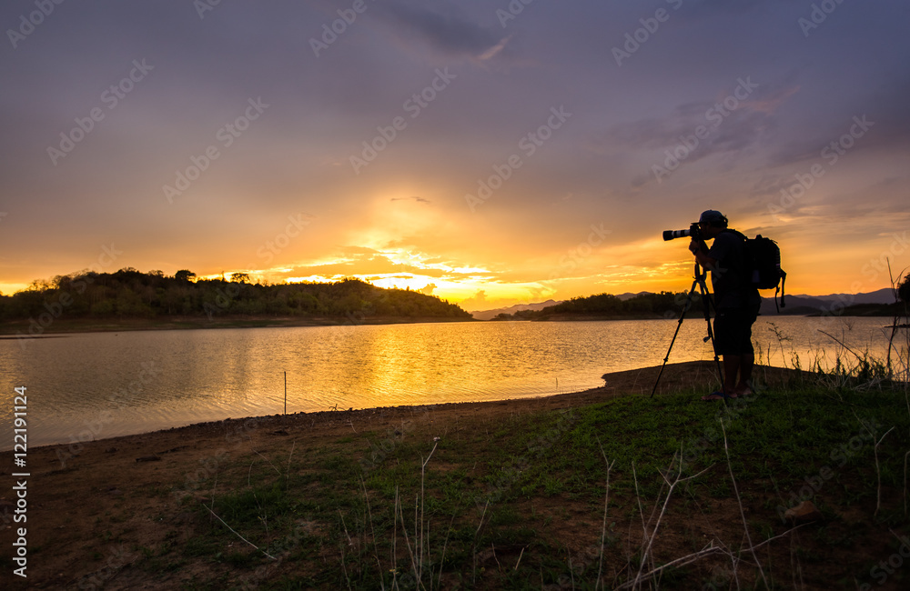 silhouette photographer at sunrise