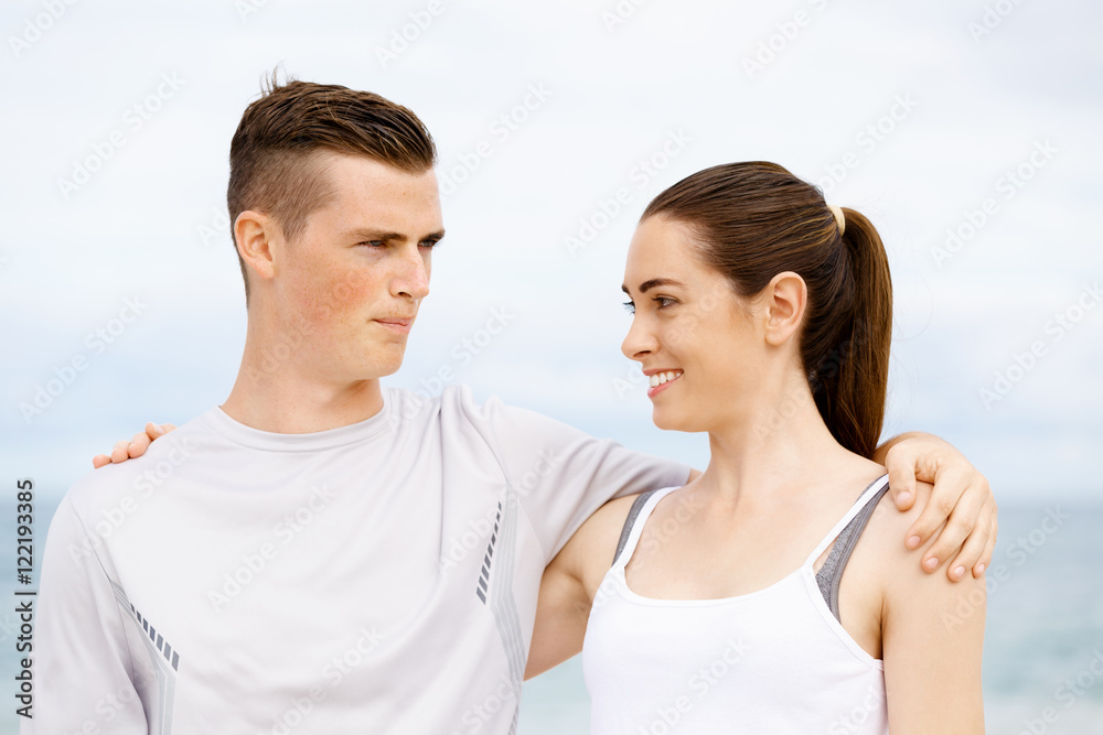 Young couple looking at each other on beach Young couple looking at each other on beach