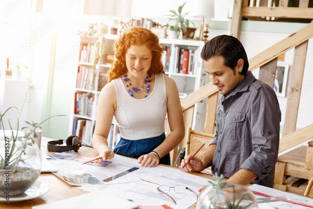 Fototapeta premium Two young architects in office