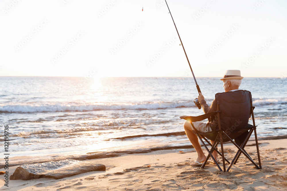 Senior man fishing at sea side Senior man fishing at sea side