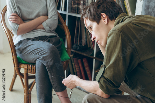 Bild auf Leinwand family conflict. Couple discussing sitting near bookshelves