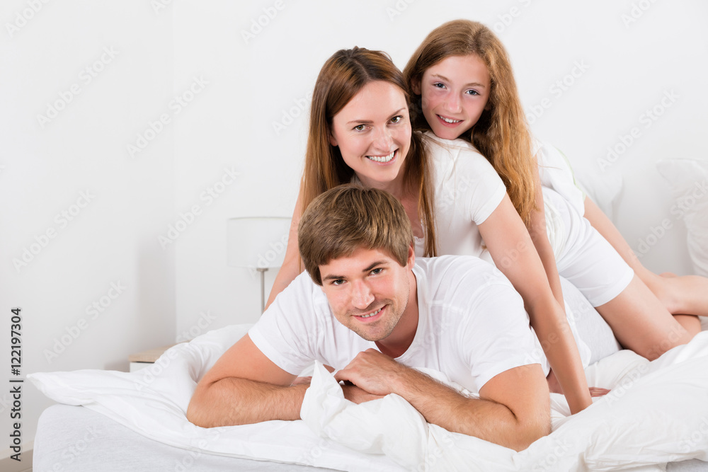 Happy Family Lying On Top Of Each Other
