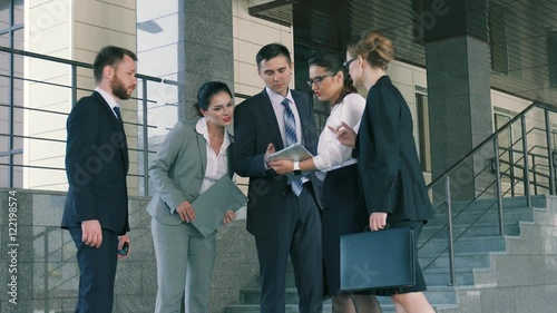 Group of ambitious business people discussing their plans before going to the meeting
