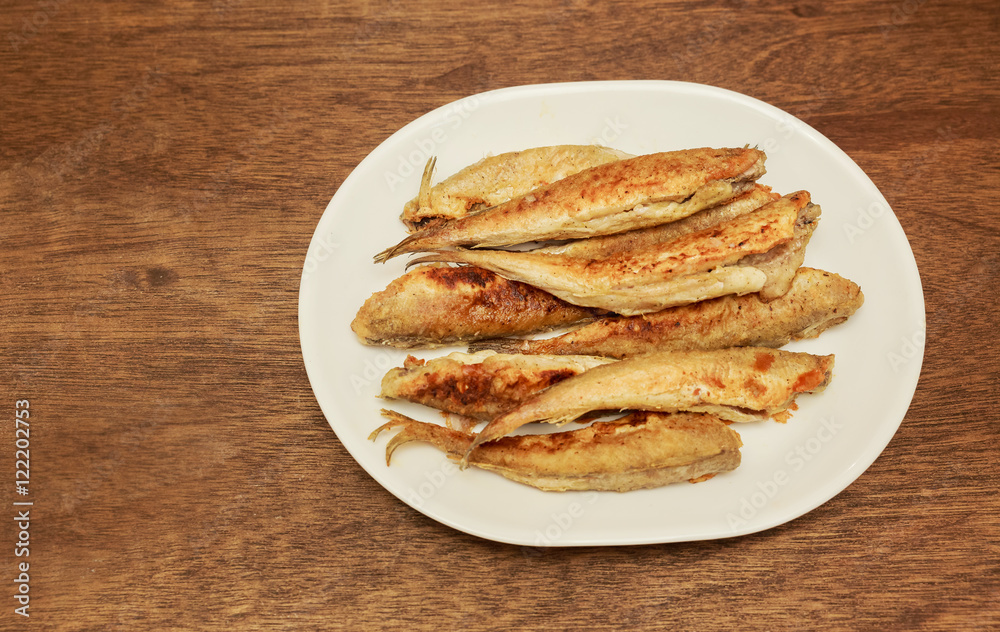 Lot of small fried fish in breadcrumbs Lot of small fried fish in breadcrumbs