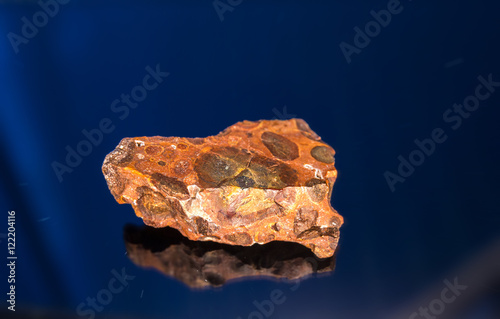 Radial blurred background view of bauxite mineral under sun light on black background photo