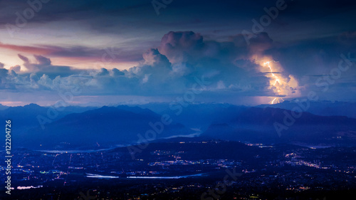 Lightening strikes mountain behind Vancouver at night