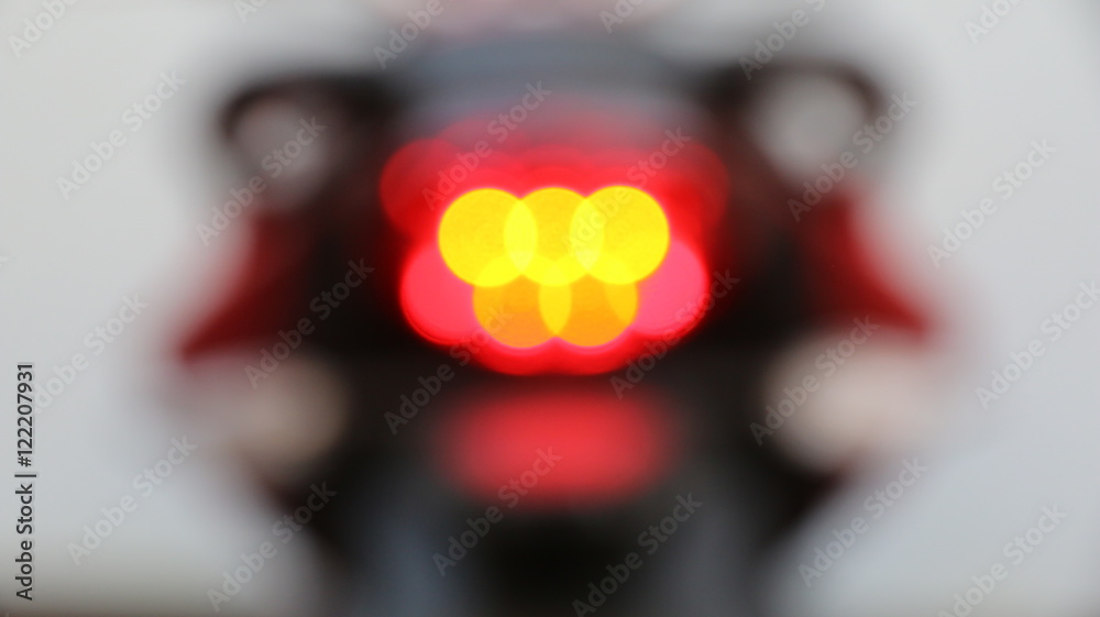 Obraz premium Motorcycle rear lights. Blurred shot.