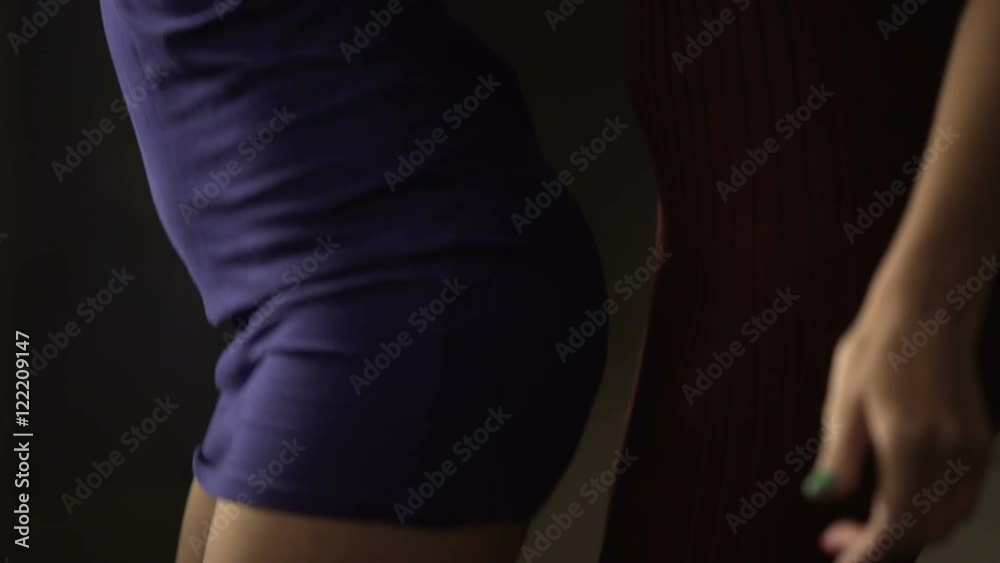 Sexy bisexual girls making seductive moves to music at party, taking off coats