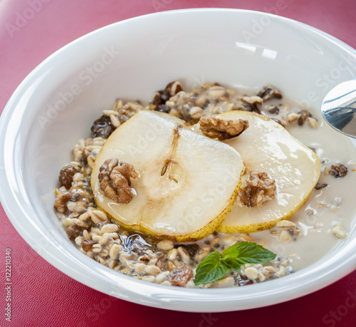 Oatmeal with pear and walnuts in the bowl